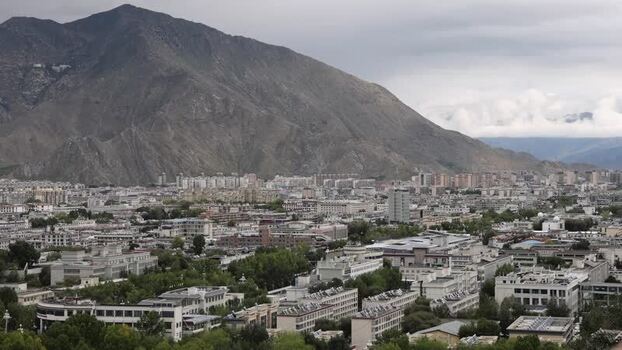 Aerial view of Lhasa city skyline with mountains China.