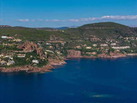 Aerial view of the rocky coastline of Le Trayas with Mediterranean villas nestled among lush green hills and deep blue waters in Saint Raphael Provence Alpes Cote d Azur France. Aerial view of the rocky coastline of Le Trayas with Mediterranean villas nestled among lush green hills and deep blue waters in Saint Raphael Provence Alpes Cote d Azur France.