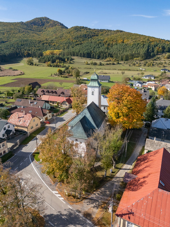 Aerial view of the church steeple piercing the skyline amidst a tapestry of autumnal hues and quaint village charm Klastor pod Znievom Zilina Region Slovakia. Aerial view of the church steeple piercing the skyline amidst a tapestry of autumnal hues and quaint village charm Klastor pod Znievom Zilina Region Slovakia.