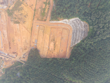 Aerial view of slope stabilization anchoring at a construction site surrounded by dense palm oil plantations in Bukit Mertajam Penang Malaysia. Aerial view of slope stabilization anchoring at a construction site surrounded by dense palm oil plantations in Bukit Mertajam Penang Malaysia.
