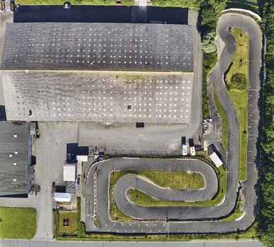 Schleswig Germany 26 June 2026 Aerial view of a disused go kart track situated on an industrial site with a large warehouse building and surrounding greenery. Schleswig Germany 26 June 2026 Aerial view of a disused go kart track situated on an industrial site with a large warehouse building and surrounding greenery.