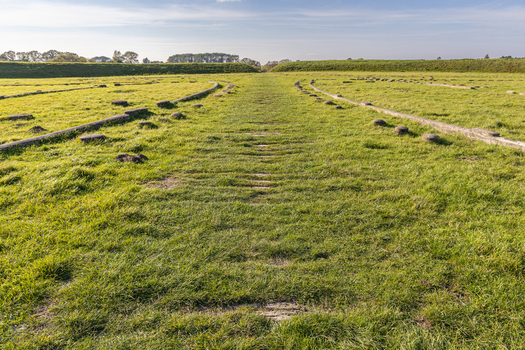 View of the Viking Fortress Trelleborg with grassy remains of circular fortifications and stone foundations in Slagelse Sjaelland Denmark. View of the Viking Fortress Trelleborg with grassy remains of circular fortifications and stone foundations in Slagelse Sjaelland Denmark.