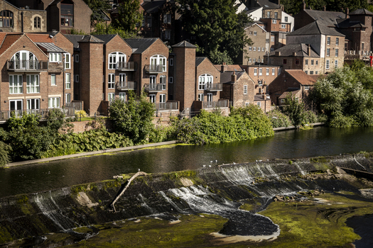 View of the River Wear and historic riverside buildings in Durham England United Kingdom. View of the River Wear and historic riverside buildings in Durham England United Kingdom.
