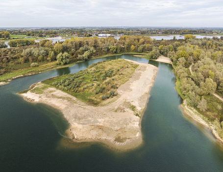 Aerial view of nature reserve Millingerwaard with winding river channels sandy banks and lush autumn foliage in Kekerdom Gelderland Netherlands.