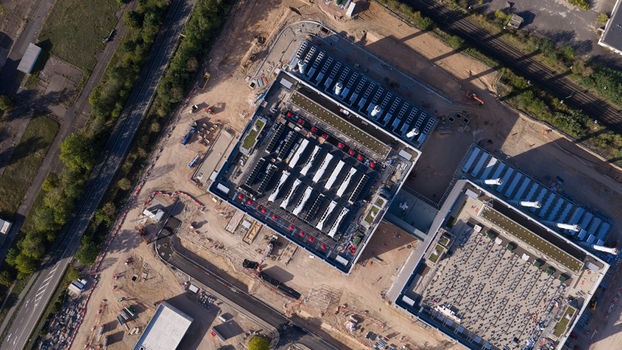 Aerial view of the Data4 Hanau data center facility featuring industrial rooftops with cooling units and surrounding construction site in Hanau Hessen Germany. Aerial view of the Data4 Hanau data center facility featuring industrial rooftops with cooling units and surrounding construction site in Hanau Hessen Germany.