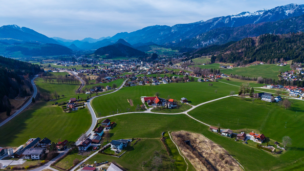 Aerial view of the verdant valley floor meeting the foothills with quaint buildings nestled amidst the landscape Windischgarsten Upper Austria Austria. Aerial view of the verdant valley floor meeting the foothills with quaint buildings nestled amidst the landscape Windischgarsten Upper Austria Austria.