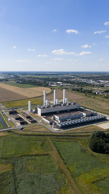 Aerial view of the GasunieAir Products nitrogen factory with white chimneys industrial buildings and cooling units set in rural fields in Muntendam Groningen Netherlands.