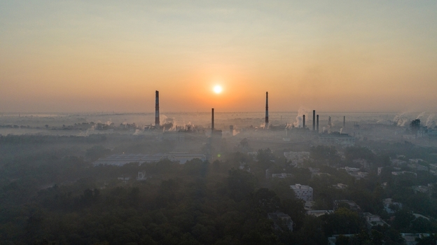 Aerial view of industrial factory chimneys emitting smoke during sunrise over the landscape of Nagda Madhya Pradesh India. Aerial view of industrial factory chimneys emitting smoke during sunrise over the landscape of Nagda Madhya Pradesh India.