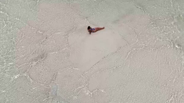 Aerial view of a woman on Man O War Cay Sandbar The Bahamas.