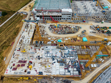 Aerial view of the Neuenstein Techno Zone construction site featuring tower cranes concrete foundations and steel framework in Neuenstein Baden Wurttemberg Germany. Aerial view of the Neuenstein Techno Zone construction site featuring tower cranes concrete foundations and steel framework in Neuenstein Baden Wurttemberg Germany.