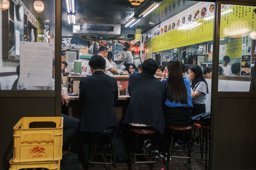 Shinjuku City Japan 30 September 2025 View of patrons seated at a cozy brightly lit eatery the warm glow contrasting with the cool tones of the exterior a scene of urban life. Shinjuku City Japan 30 September 2025 View of patrons seated at a cozy brightly lit eatery the warm glow contrasting with the cool tones of the exterior a scene of urban life.