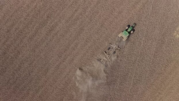 Aerial view of a tractor plowing a dry field Portugal. Aerial view of a tractor plowing a dry field Portugal.