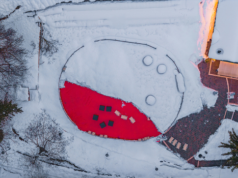 Aerial view of a circular red surface set within a snow covered landscape in Rivisondoli Abruzzo Italy.