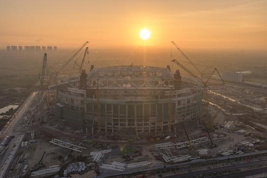 Aerial view of PVF Stadium under construction with multiple cranes and scaffolding during a golden sunset in Hanoi Ha Noi Vietnam. Aerial view of PVF Stadium under construction with multiple cranes and scaffolding during a golden sunset in Hanoi Ha Noi Vietnam.