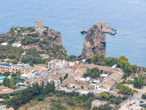 Aerial view of Riserva Naturale Orientata dello Zingaro with historic watchtower rocky cliffs and coastal village buildings in San Vito Lo Capo Sicilia Italy. Aerial view of Riserva Naturale Orientata dello Zingaro with historic watchtower rocky cliffs and coastal village buildings in San Vito Lo Capo Sicilia Italy.