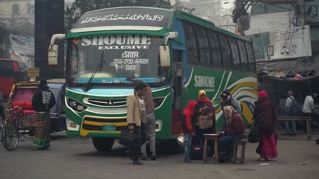 View of a green passenger bus parked on a busy street Bangladesh. View of a green passenger bus parked on a busy street Bangladesh.