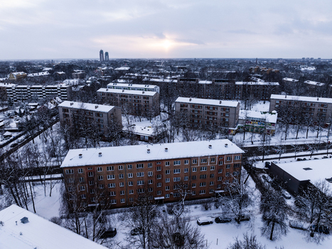 Aerial view of the snow covered Agenskalna priedes neighborhood with residential apartment buildings and bare trees under a winter sky in Riga Latvia. Aerial view of the snow covered Agenskalna priedes neighborhood with residential apartment buildings and bare trees under a winter sky in Riga Latvia.