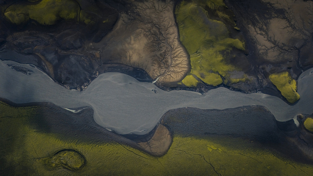 Aerial view of Langisjor featuring dark volcanic soil vibrant green mossy terrain and intricate river patterns in Vik Skaftarhreppur Iceland. Aerial view of Langisjor featuring dark volcanic soil vibrant green mossy terrain and intricate river patterns in Vik Skaftarhreppur Iceland.