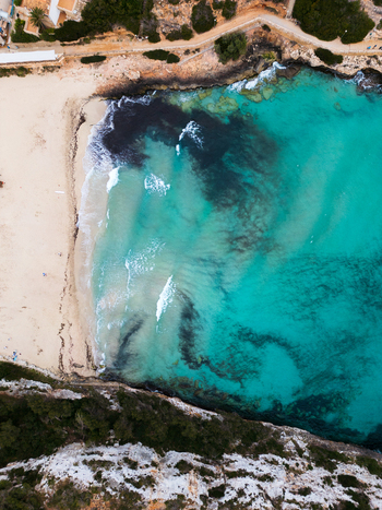 Aerial view of Cala Mendia beach with turquoise waters and white sand surrounded by rocky cliffs Cala Mendia Illes Balears Spain. Aerial view of Cala Mendia beach with turquoise waters and white sand surrounded by rocky cliffs Cala Mendia Illes Balears Spain.