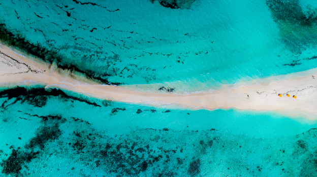 Aerial view of the white sandbar of Los Roques archipelago surrounded by turquoise Caribbean waters and coral reefs in Los Roques Dependencias Federales Venezuela. Aerial view of the white sandbar of Los Roques archipelago surrounded by turquoise Caribbean waters and coral reefs in Los Roques Dependencias Federales Venezuela.