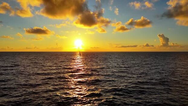 Aerial view of a sailboat at sunset in Kawaihae United States. Aerial view of a sailboat at sunset in Kawaihae United States.