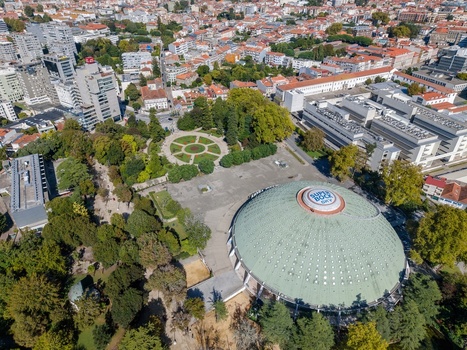 Aerial view of Jardins do Palacio de Cristal and the Super Bock Arena dome surrounded by lush greenery and urban cityscape in Porto Porto Portugal.