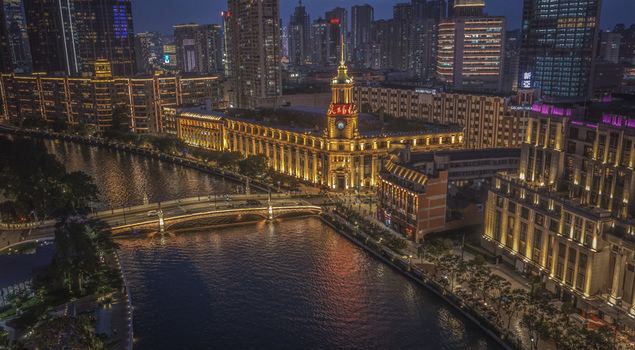 Aerial view of the illuminated Shanghai Postal Museum and Sichuan Road Bridge over Suzhou Creek at night in Shanghai Shanghai China. Aerial view of the illuminated Shanghai Postal Museum and Sichuan Road Bridge over Suzhou Creek at night in Shanghai Shanghai China.