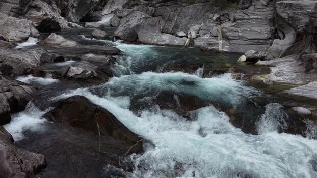Aerial view of the Verzasca River flowing over rocks Switzerland. Aerial view of the Verzasca River flowing over rocks Switzerland.