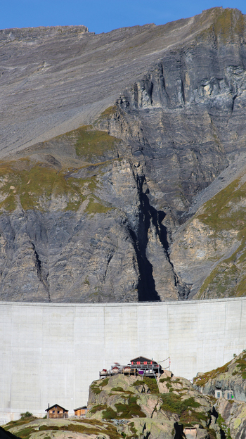 View of the Lac du Vieux Emosson dam set against the rugged rocky mountains of the Swiss Alps in Finhaut Valais Switzerland. View of the Lac du Vieux Emosson dam set against the rugged rocky mountains of the Swiss Alps in Finhaut Valais Switzerland.