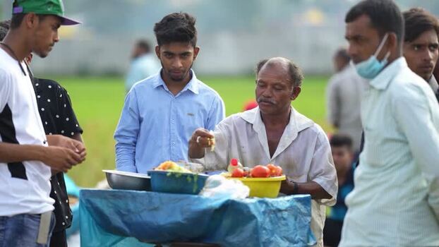 View of a street food vendor preparing snacks in Bogura Bangladesh. View of a street food vendor preparing snacks in Bogura Bangladesh.