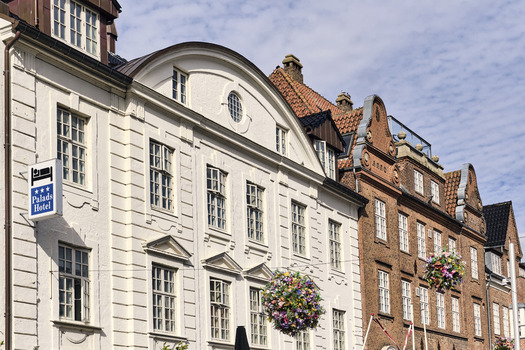 Viborg Denmark 07 August 2026 View of Neoclassical facades in the town center including the Palads Hotel with its white stucco exterior and adjacent red brick buildings. Viborg Denmark 07 August 2026 View of Neoclassical facades in the town center including the Palads Hotel with its white stucco exterior and adjacent red brick buildings.