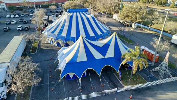 Aerial view of striking blue and white striped circus tents standing boldly against the neutral toned parking lot a vibrant spectacle under the Florida sun St. Augustine Florida United States. Aerial view of striking blue and white striped circus tents standing boldly against the neutral toned parking lot a vibrant spectacle under the Florida sun St. Augustine Florida United States.