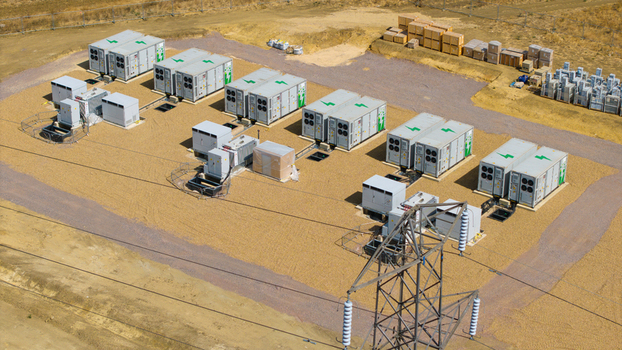 Aerial view of the Eaton Socon Substation featuring battery energy storage systems electrical transformers and a high voltage transmission tower on a gravel site in St. Neots England United Kingdom. Aerial view of the Eaton Socon Substation featuring battery energy storage systems electrical transformers and a high voltage transmission tower on a gravel site in St. Neots England United Kingdom.