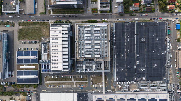 Aerial view of the Equinix Data Center featuring large industrial buildings with rooftop cooling units solar panels and parking areas in Frankfurt am Main Hessen Germany.