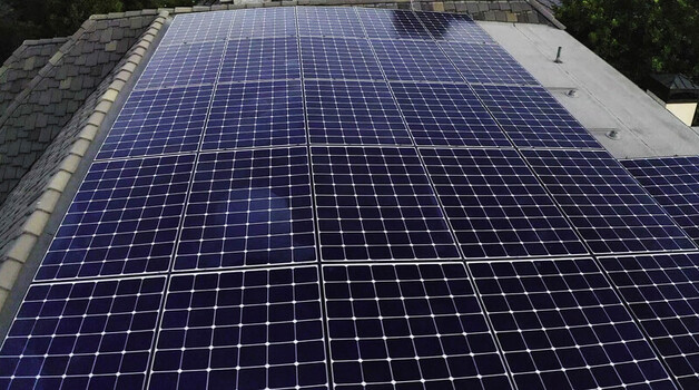 Aerial view of a roof mounted solar photovoltaic array on a residential home in Los Angeles CA United States.