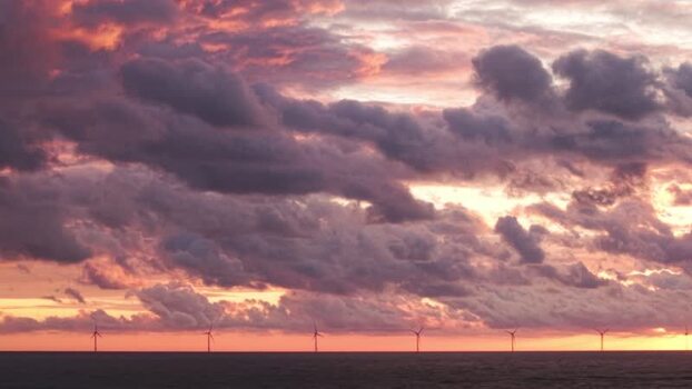 Aerial view of offshore wind farm at sunset in Hvide Sande Denmark.