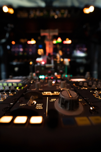 View of the illuminated cockpit control panel of a Boeing 737 800 aircraft with glowing switches and knobs at Hannover Airport in Langenhagen Niedersachsen Germany. View of the illuminated cockpit control panel of a Boeing 737 800 aircraft with glowing switches and knobs at Hannover Airport in Langenhagen Niedersachsen Germany.