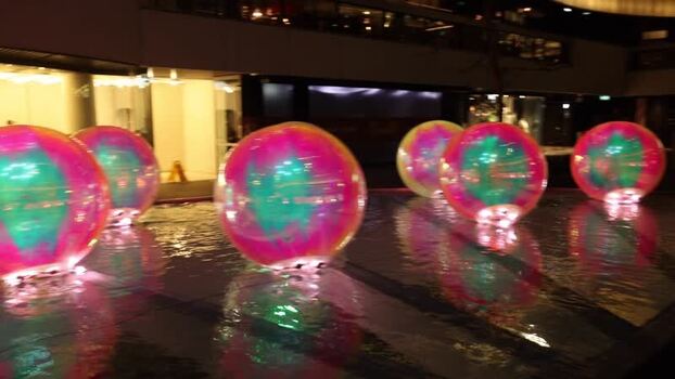 View of glowing iridescent spheres in a water feature Australia.