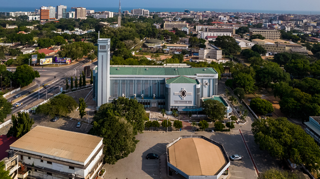 Aerial view of the Holy Spirit Cathedral in Accra surrounded by lush trees urban streets and the cityscape of Accra Greater Accra Region Ghana. Aerial view of the Holy Spirit Cathedral in Accra surrounded by lush trees urban streets and the cityscape of Accra Greater Accra Region Ghana.
