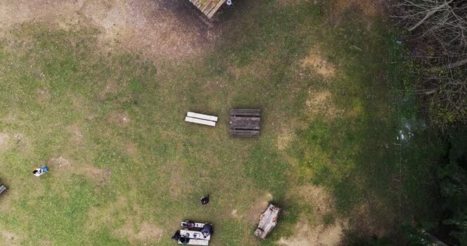 Aerial view of picnic tables on a grassy clearing Italy. Aerial view of picnic tables on a grassy clearing Italy.