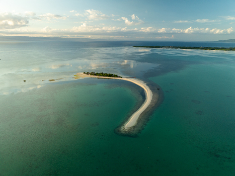 Aerial view of Pungtud sandbank surrounded by turquoise waters and coral reefs in Panglao Philippines. Aerial view of Pungtud sandbank surrounded by turquoise waters and coral reefs in Panglao Philippines.