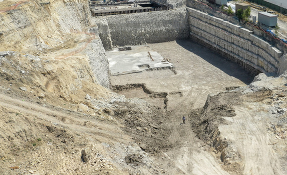 Aerial view of a large construction site excavation with deep retaining walls and a concrete foundation base in Sariyer Istanbul Turkiye. Aerial view of a large construction site excavation with deep retaining walls and a concrete foundation base in Sariyer Istanbul Turkiye.