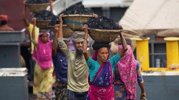 View of workers carrying coal baskets in Aminbazar Bangladesh.