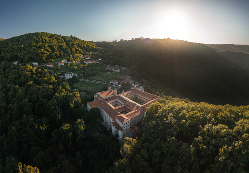 Aerial view of the Monastery of Santo Estevo de Ribas de Sil nestled within the lush forests of the Ribeira Sacra region in O Covelo Ourense Spain.