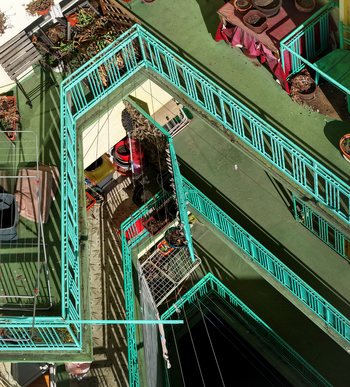 Aerial view of a residential building courtyard with turquoise metal railings potted plants and laundry drying racks in Belgrade City of Belgrade Serbia. Aerial view of a residential building courtyard with turquoise metal railings potted plants and laundry drying racks in Belgrade City of Belgrade Serbia.
