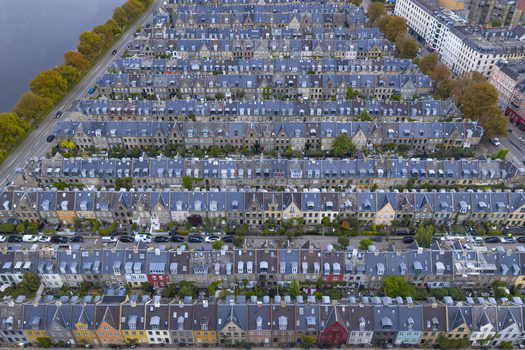 Aerial view of Kartoffelraekkerne historic terraced houses with uniform rooftops and colorful facades near the lakes in Copenhagen Denmark. Aerial view of Kartoffelraekkerne historic terraced houses with uniform rooftops and colorful facades near the lakes in Copenhagen Denmark.