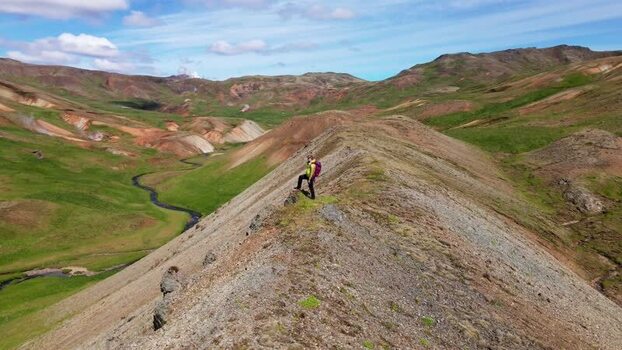 Aerial view of hiker standing on the ridge of Grensdalur Iceland. Aerial view of hiker standing on the ridge of Grensdalur Iceland.