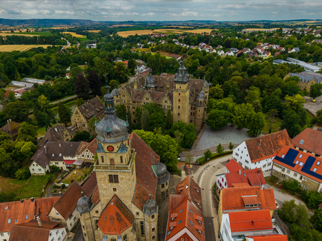 Aerial view of Neuenstein Castle surrounded by lush greenery historic rooftops and the town of Neuenstein Neuenstein Baden Wurttemberg Germany. Aerial view of Neuenstein Castle surrounded by lush greenery historic rooftops and the town of Neuenstein Neuenstein Baden Wurttemberg Germany.