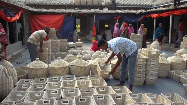 View of workers organizing woven baskets in Bogura Bangladesh. View of workers organizing woven baskets in Bogura Bangladesh.