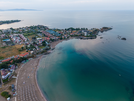 Aerial view of Arapya Beach with turquoise water sandy shoreline beach umbrellas and surrounding coastal buildings in Tsarevo Burgas Bulgaria. Aerial view of Arapya Beach with turquoise water sandy shoreline beach umbrellas and surrounding coastal buildings in Tsarevo Burgas Bulgaria.